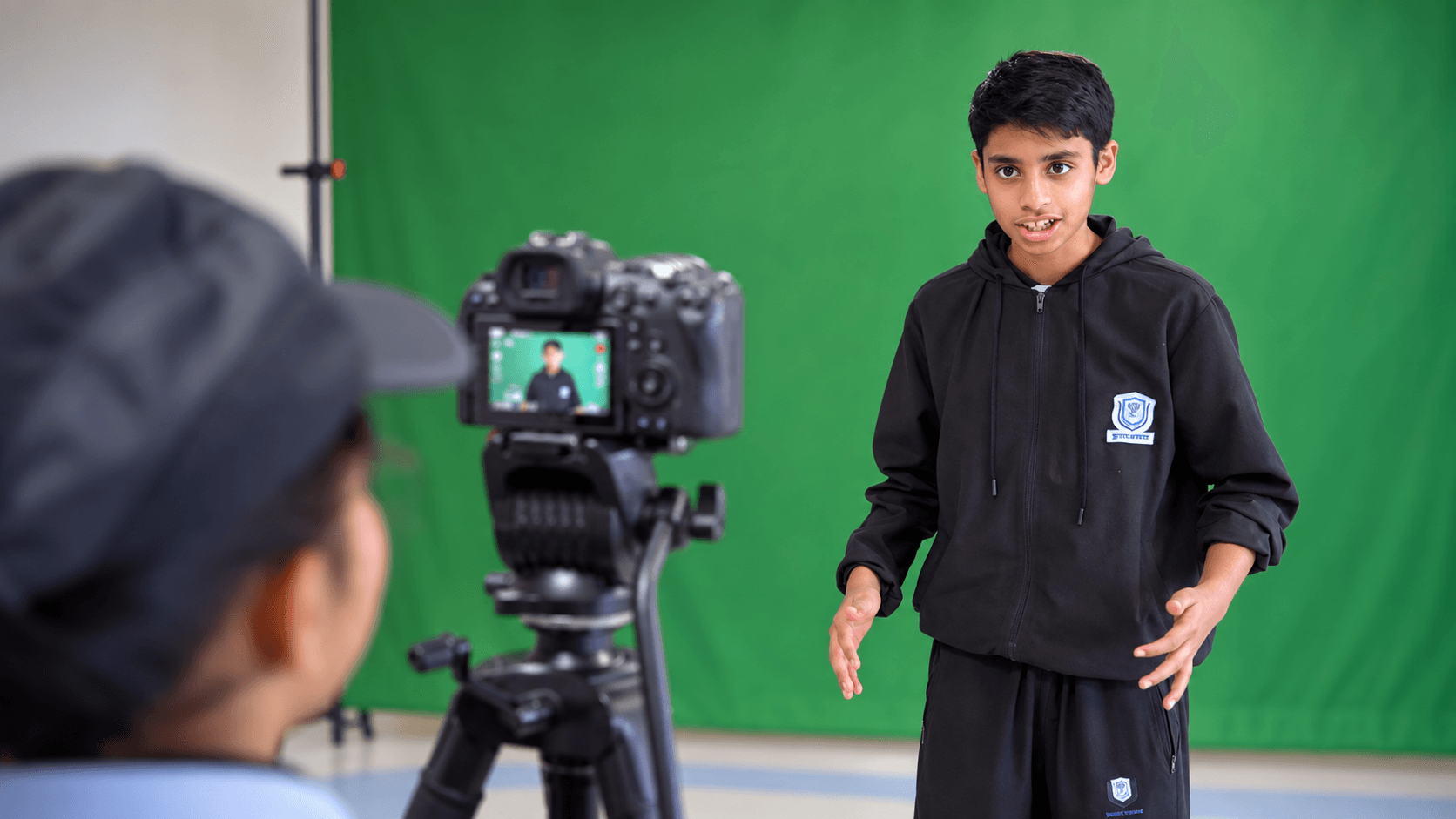 A student recording a First Take presentation in front of a camera